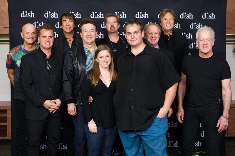 John Merrill meets the band Chicago after he addresses a crowd at a Dish Network event
